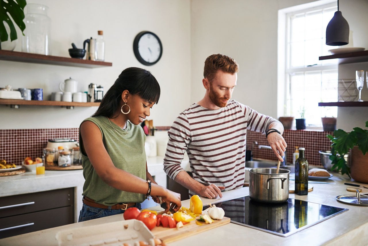 Couple preparing a salad in their kitchen