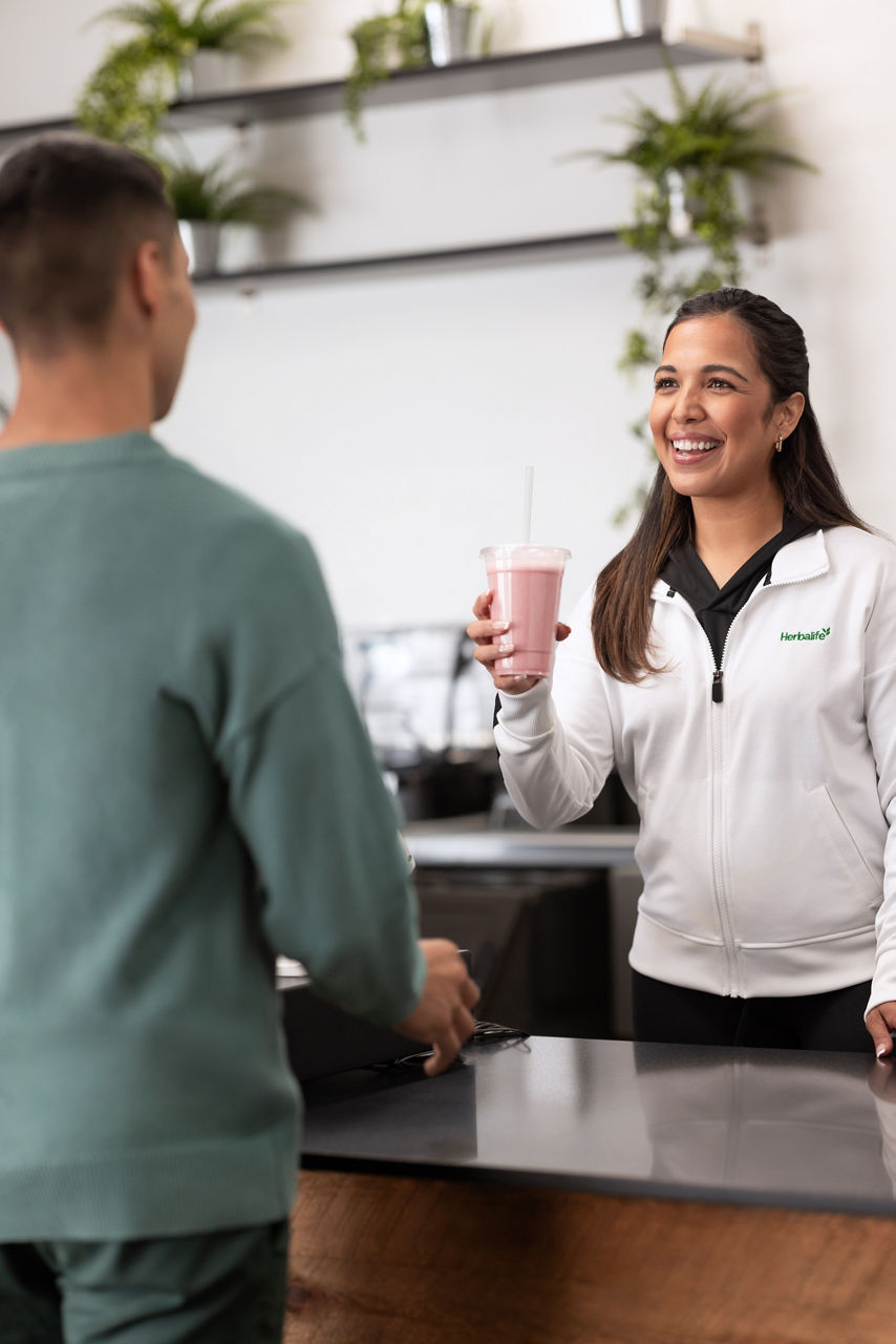 Man receiving a shake from a friend.