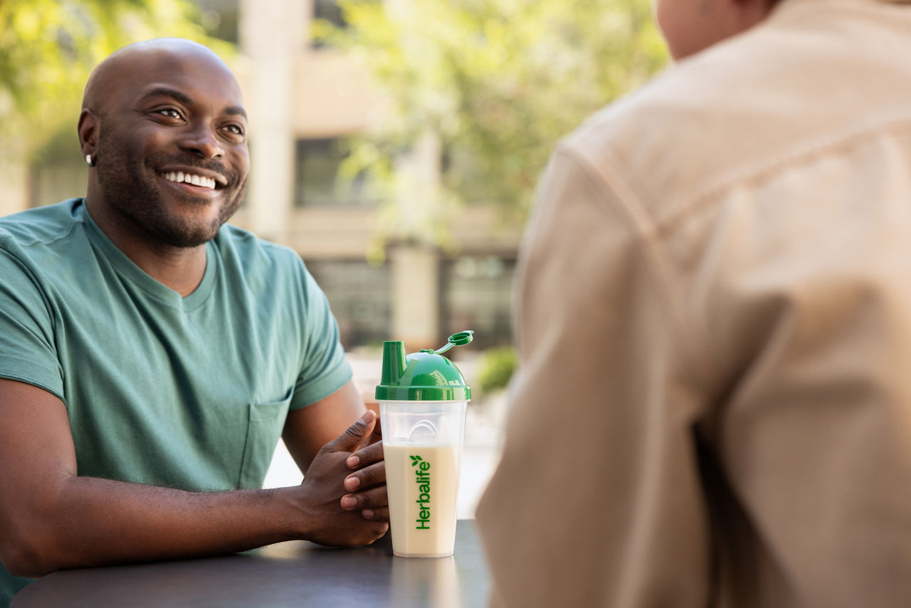 Smiling man sitting with F1 Shake