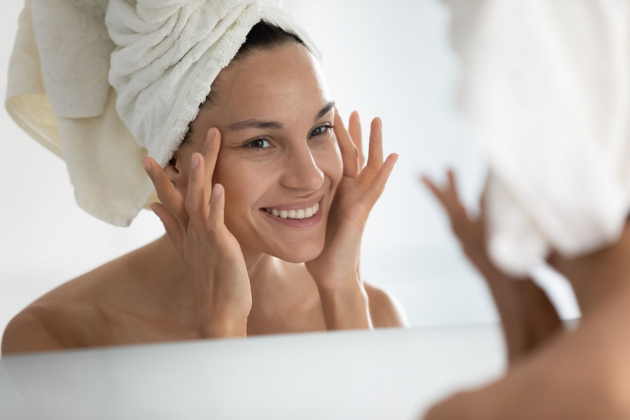 A woman doing skincare at home