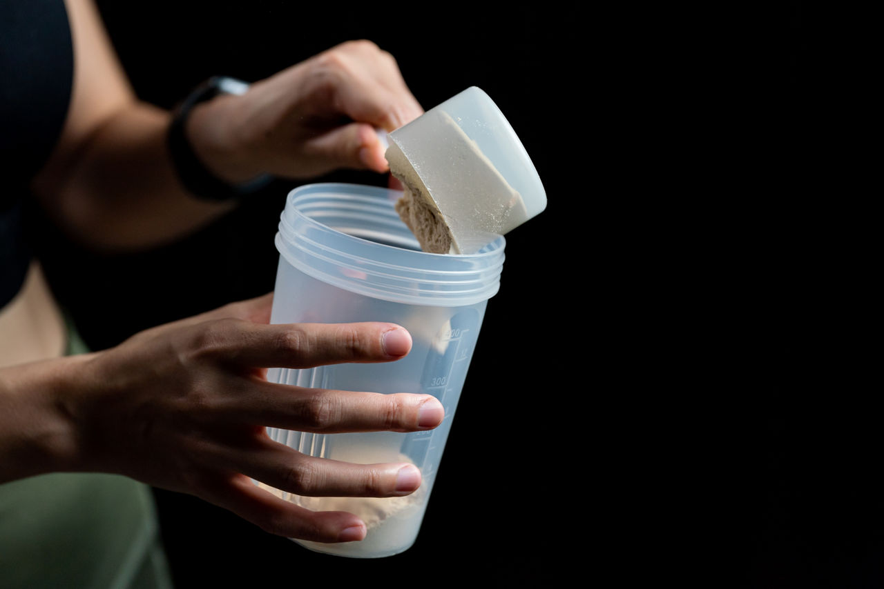 A woman making a protein shake