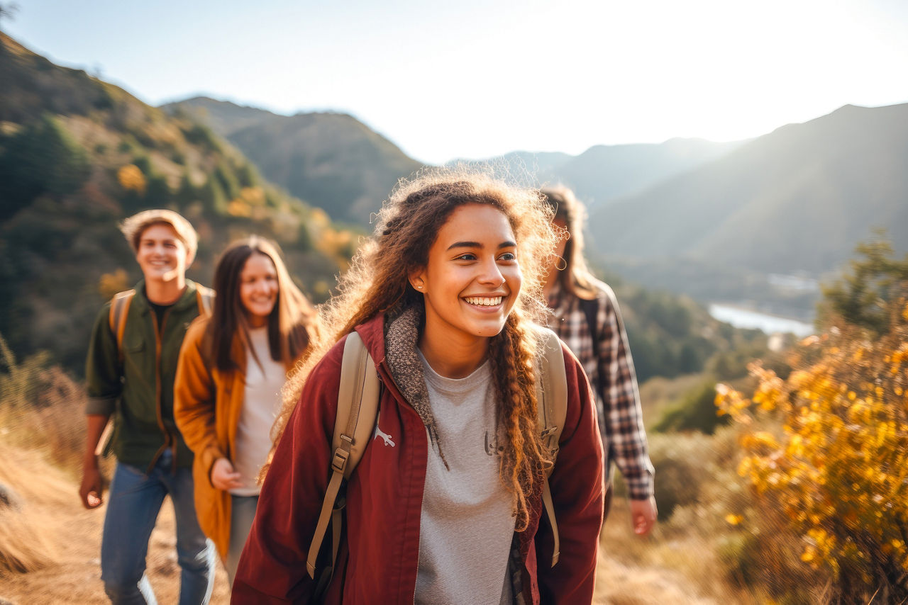 A group of teenagers hiking and enjoying nature in the mountains