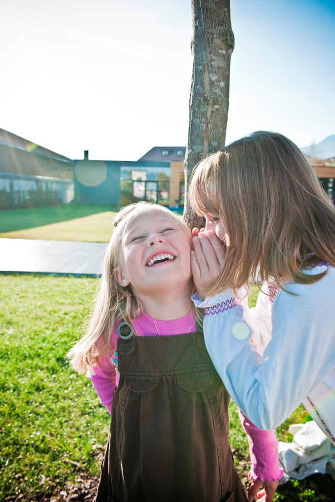 Two girls whispering